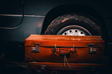 Vintage car wheel with a vintage suitcase. 