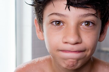 Portrait of a fun and happy boy enjoying his bath © Wirestock