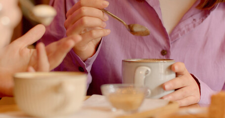 Close-up mug with hot drink. Communication among people during breakfast or brunch involves sipping...