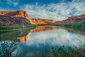 Beautiful view of the Colorado River with canyon cliffs on its banks on a sunny day in Utah