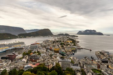 Aerial of the Alesund city surrounded by the North Sea and the hills during the daytime