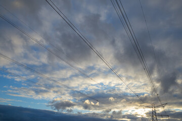 high voltage electric tower with cloudy sky background, pylon 
