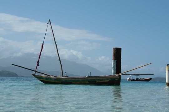 Fisherman sailboat on calm ocean water off the coast of Cap Haitien, in Haiti