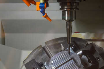 The 5-axis CNC milling machine  cutting the automotive part with solid ball end mill tool.