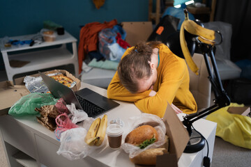 Tired student sleeping while preparing for exams in dirty, messy room © Andrii Lysenko