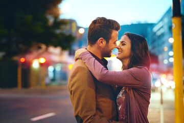 Couple, night and city with hug for romance, bonding and love in relationship with life partner. Happiness, affection and people with commitment and trust, sweet moment and romantic together outdoor