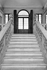 Black and white photo of stairs inside historic palace in the italian city of Padova