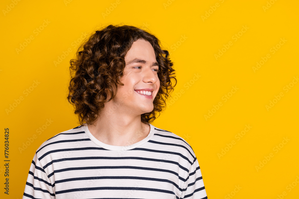 Sticker Portrait of attractive brunet curls teenage guy looking empty space smiling good emotions memories isolated on yellow color background