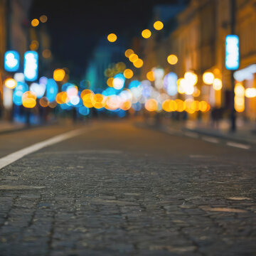 Blurred background of a city street without cars in perspective. Night lighting with bokeh. Layout for design.