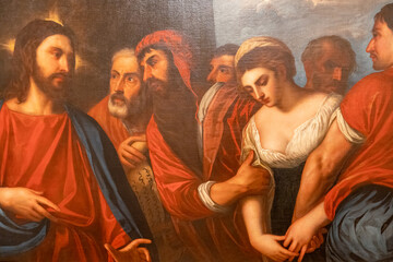 Detail of old religious painting showing a woman brought to Jesus by other men
