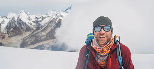 Papier Peint photo Lavable Lhotse Cheerful laughing climber in sunglasses portrait with backpack ascending Mera peak high slopes at 6000m enjoying legendary Mount Everest, Nuptse, Lhotse with South Face wall beautiful High Himalayas.