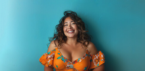30s latina woman in a floral dress is smiling and posing, plus size on blue background 