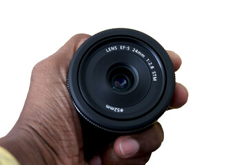 DSLR camera lens - digital camera lens 24 mm prime lens hold in hand with isolated Background