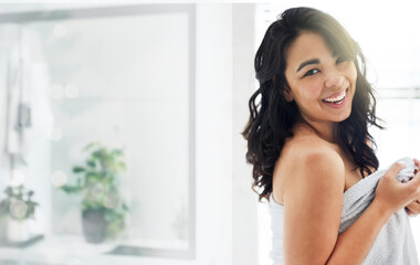 Woman, portrait and towel in bathroom after shower, body care and cleaning for hygiene in home. Female person, spa treatment and morning routine for cosmetics, dermatology and smile for grooming