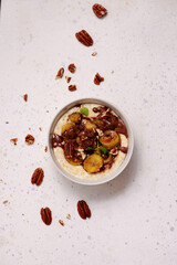 Oatmeal with caramel bananas and chocolate in to the bowl