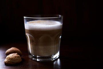 Coffee with milk on rustic wooden background. Soft focus. Close up. Copy space.