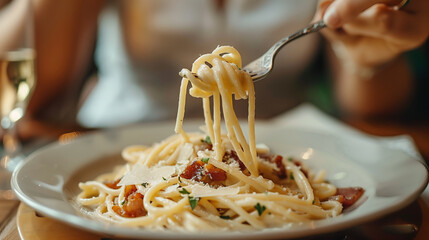 In a close-up image, spaghetti pasta carbonara is elegantly twirled on a fork, adorned with cheese and bacon bits, set against a warm bokeh background, creating a mouthwatering culinary scene.