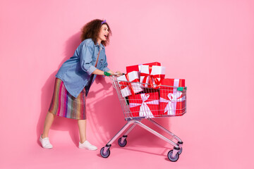 Full length photo of funky impressed lady dressed jeans outfit buying birthday gifts emtpy space...