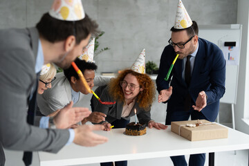 Group of business people celebrating birthday at office