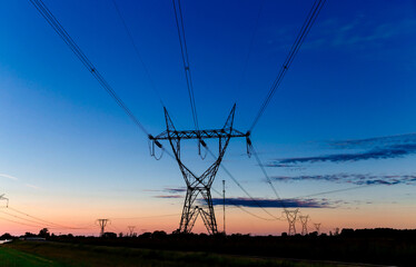 High voltage Transmission towers at the sunset