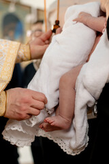 Obraz na płótnie Canvas Baptism of a small child in the Orthodox Church 