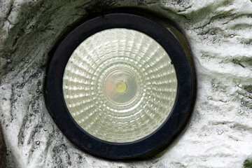 Round LED light eye embadded in stone figure  