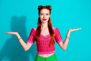 Naklejki  Photo of funky cute lady dressed pink knitted shirt comparing arms emtpy space isolated blue color background
