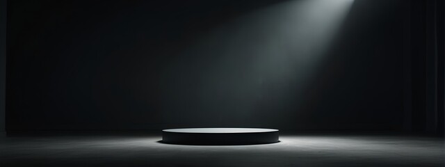 Spotlight on circular pedestal in dark room