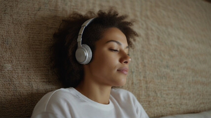 Side view shot of relaxed woman listening to music with headphones lying on carpet at home. AI generative