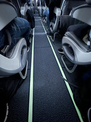 Aisle of an Airplane Ready for Takeoff with Passengers Seated