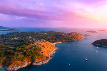 Beautiful Nai Harn beach with white yachts, sunset on Rawai resort with windmill, travel paradise...