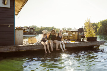 Happy senior female friends enjoying together during vacation on houseboat