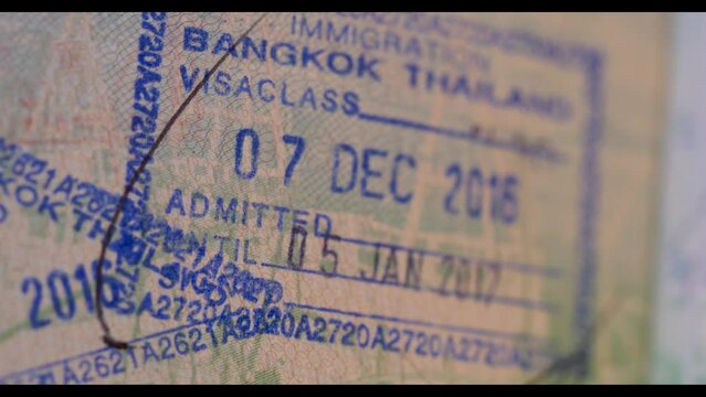 4K Panning shot of Visa Entry Stamp in Passport - Typical Visa on Arrival stamp for holiday makers and tourists to Bangkok Thailand