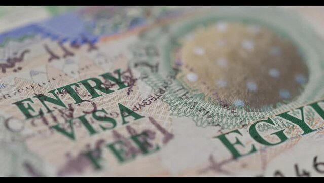 4K Panning shot of Visa Entry Stamp in Passport - Typical Visa on Arrival stamp for holiday makers and tourists to Egypt