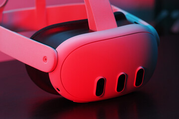 Close-up. Virtual reality headset lit red neon light.