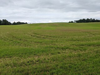 A farm field of cut hay in the summer