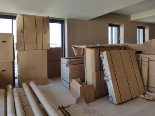 Boxes of furniture waiting to be assembled in a new apartment on construction site