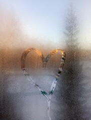 Heart on the condensation of the window. 