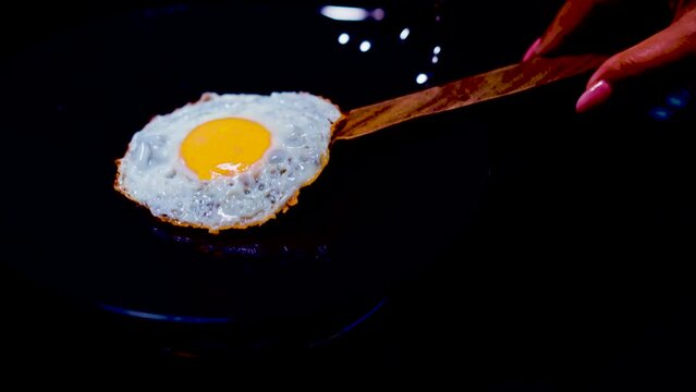 fried egg on a frying pan fried eggs with chives in an iron pan