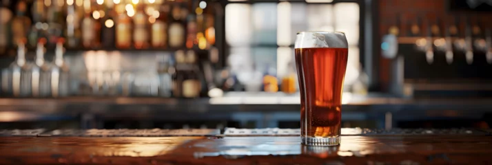 Foto op Plexiglas A glasses of beer on a wooden table in a pub, bokeh background, A pint of frothy craft beer sits on a rustic wooden bar counter, inviting a refreshing experience. glass of beer kept on a bar counter,  © Faiza