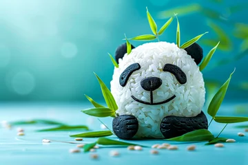 Fotobehang Close-up of a smiling panda rice ball surrounded by bamboo leaves, with ample sky for text on creativity in cuisine © weerasak