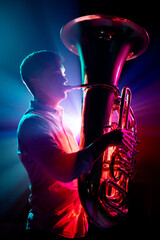Silhouette of artistic, talented musician, trumpeter performing his new symphony in neon light against black background. Concept of hobby and work, music festivals, concerts, symphony show, culture. - obrazy, fototapety, plakaty