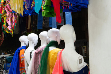 Female mannequin , Rajasthani womens clothes being sold in a shop at famous Jodhpur market in the evening. Rajasthan, India.