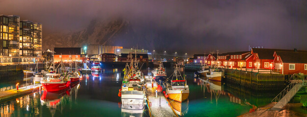 Panoramic view of the waterfront harbour and fishing boats at night in the beautiful fishing town of Svolvaer, the largest city and administrative centre of the Lofoten Islands in Northern Norway