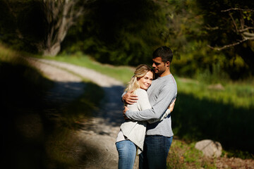Couple, hug and happy in park for love, bonding with care and support in healthy relationship. Man,...