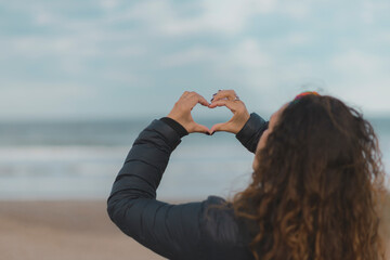 woman doing heart shape with her hands