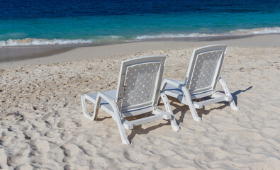 Beautiful beach. Chairs on the sandy beach near the sea. Summer holiday and vacation concept for tourism.
