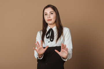 Confident Female Executive Extending Arms Forward in a Stop Gesture, Signifying an End to...