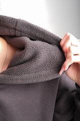 catalog shooting of a dark hoodie on a person