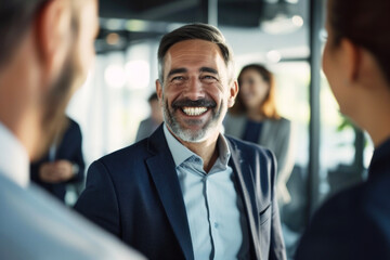 Charismatic Businessman Sharing a Laugh with Colleagues in a Modern Corporate